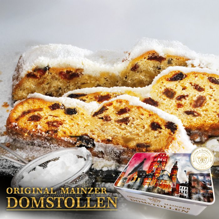 Im Hintergrund liegen Scheiben eines Christstollens. Davor eine Blechdose mit einer Illustration des Mainzer Doms. Text: Original Mainzer Christstollen – Hier bestellen